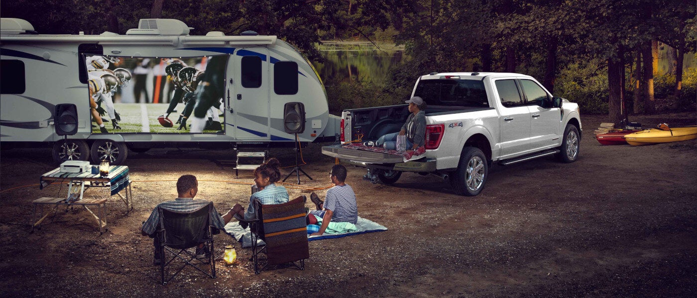 2026 Ford F-150 in a forest with RV and family