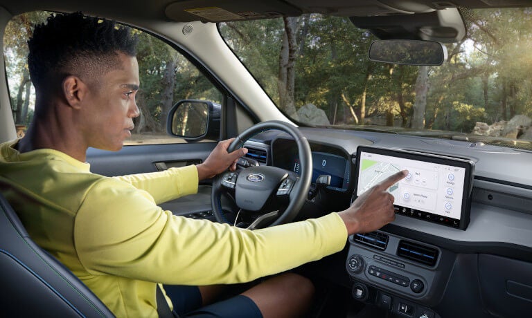 2026 Ford Maverick with driver using infotainment system