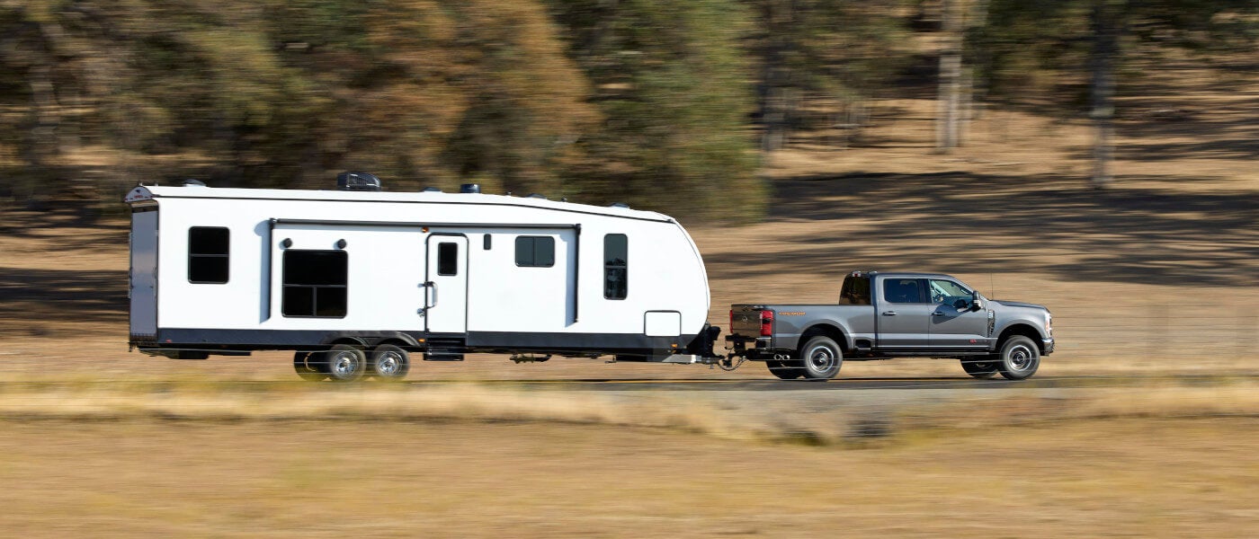 2026 Ford Super Duty towing an RV side view