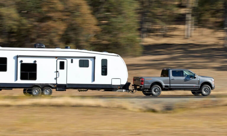 2026 Ford Super Duty side view towing an RV