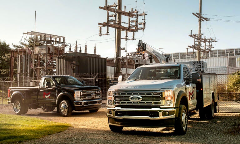 2026 Ford Super Duty pair parked by power plant